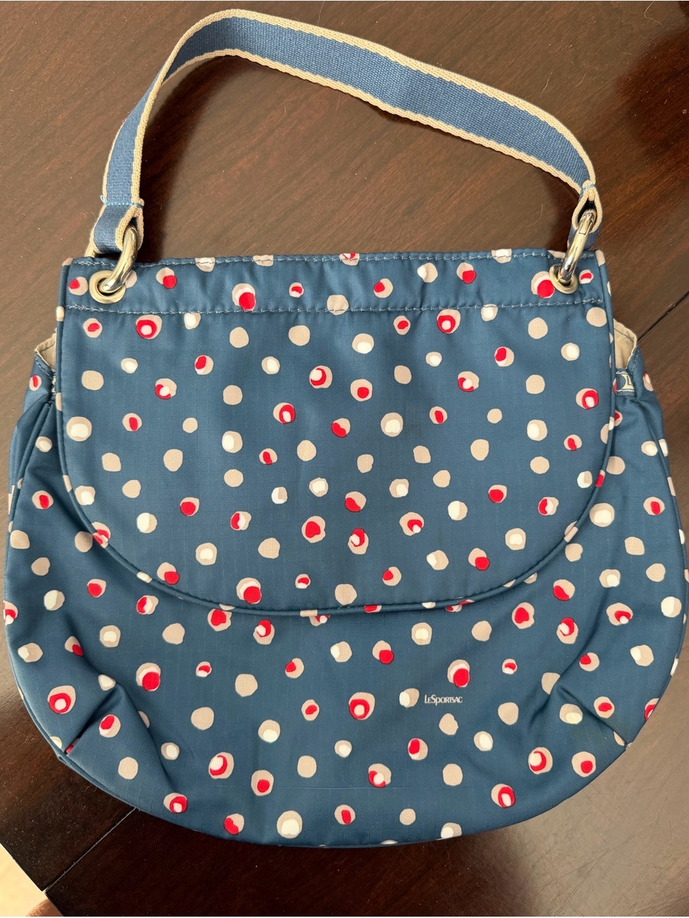 Lesportsac Nylon Blue Crescent Shaped Shoulder Bag with Boho Polka Dot Pattern.